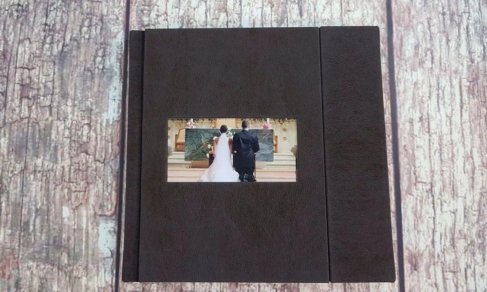 Álbum de casamento Alfafotobook Pro com capa de couro preto e foto centralizada.